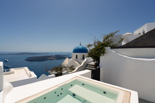a view of the ocean from the balcony of a house at U & ME SUITES in Fira