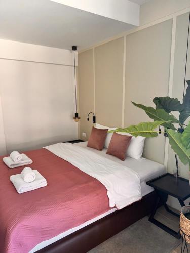 a bedroom with a large bed with towels on it at Green Stone Apartments in Rafailovici