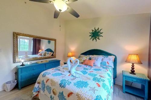 a bedroom with a bed with swans on it at Townhomes of Providence --- 9 John Hall Dr in Ocean View