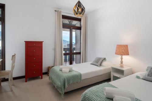 a bedroom with two beds and a window at Charming Villa, spacious, beautiful views! in Funchal