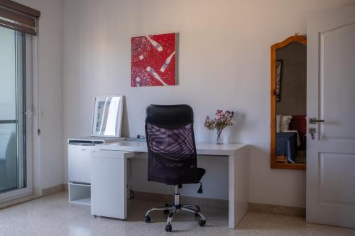 an office with a desk with a chair and a computer at Home Sweet Home in St Julian's