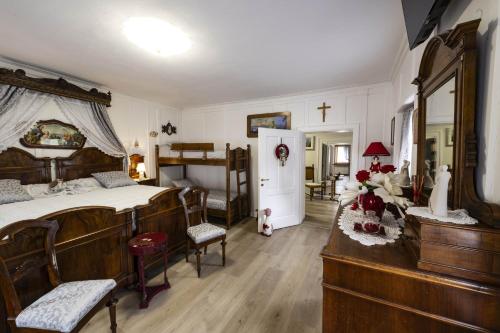 a bedroom with a large bed with wooden furniture at Palazzo Cervesato Appartamento: Maria Luisa in Santo Stefano di Cadore
