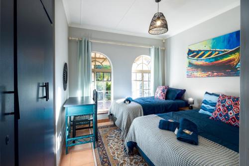 a living room with a bed and a couch at Pelican Palms Aston Jeffreys Bay in Jeffreys Bay