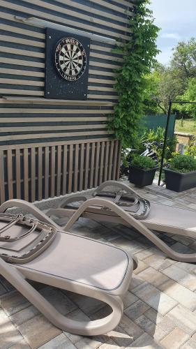 a metal bed on a patio in front of a wall at Relax Balaton Apartmanok in Balatonfüred