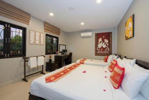 a bedroom with a large white bed in a room at Baan Santhiya Private Pool Villas - Free Tuk-Tuk Service to the Beach! in Ao Nang Beach