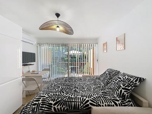 - une chambre avec un lit noir et blanc et un bureau dans l'établissement studio cocooning sanary sur mer, à Sanary-sur-Mer