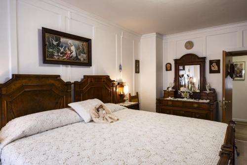 a bedroom with a bed and a dresser and a mirror at Palazzo Cervesato Appartamento: Maria Luisa in Santo Stefano di Cadore