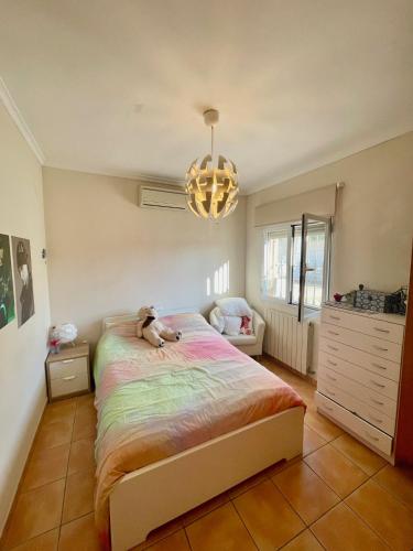 a bedroom with a bed with a teddy bear on it at Casa Claudia in Calpe