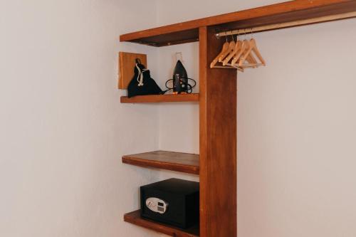 a room with wooden shelves and a black box at Casa Real Sayulita Hotel Boutique in Sayulita