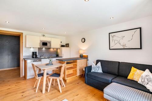 a living room with a couch and a table at Ferienwohnung Nordic -Reit im Winkl in Reit im Winkl