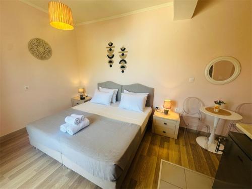 a bedroom with a large bed and a bathroom at Nikos Apartments Corfu in Agios Stefanos