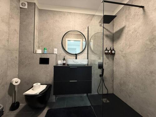 a bathroom with a sink and a mirror at Serenity retreats VRT in Şelimbăr