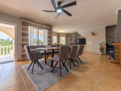 a dining room with a ceiling fan and a table and chairs at Holiday Home Villa Luz del Sol by Interhome in L'Ametlla de Mar