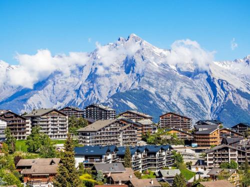 a city with a mountain in the background at Holiday Home Echo du Mihi by Interhome in Nendaz
