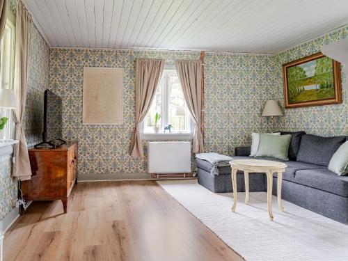 a living room with a couch and a table at Holiday Home Lövåsen by Interhome in Bottnaryd