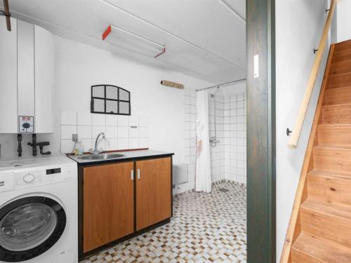 a bathroom with a washer and a sink and a washing machine at Holiday Home Gise - 2-8km from the sea by Interhome in Humble