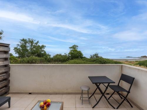 - un balcon avec 2 chaises et une table avec des fruits dans l'établissement Studio Casa Brigitte by Interhome, à Linguizzetta