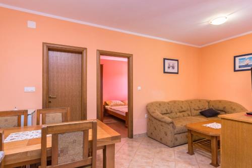 a living room with a couch and a table at Apartments Villa Orange in Medulin