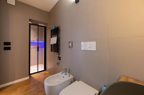 a bathroom with a toilet and a sink at Meg Lifestyle Hotel & Apartaments in Riccione