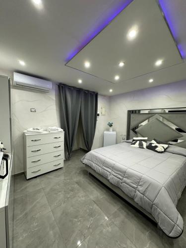 een slaapkamer met een groot bed en een witte dressoir bij Patty House in Napels