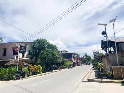 an empty street in a small town with buildings at PEPAYEN Homestay in General Luna