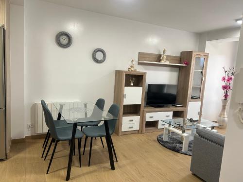 a living room with a glass table and chairs at Patuka 1 in Negreira