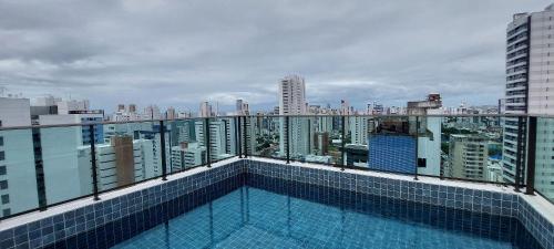 a swimming pool on the roof of a building at Allure Residence - Studios em Boa Viagem por Yolo in Recife