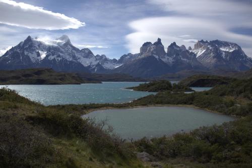 a lake in front of a mountain range at Pampa Lodge, Quincho & Caballos in Torres del Paine
