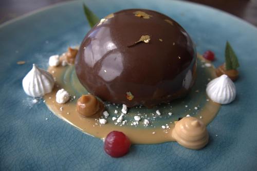 a chocolate covered dessert on a blue plate at Pampa Lodge, Quincho & Caballos in Torres del Paine
