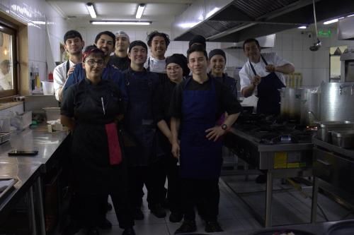 a group of chefs posing for a picture in a kitchen at Pampa Lodge, Quincho & Caballos in Torres del Paine