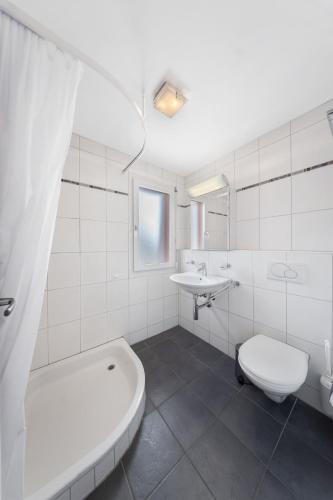a white bathroom with a toilet and a sink at Casa Camelia App 5055 in Contra