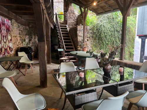 a patio with tables and chairs and a staircase at Am Hirtenturm, anno 1397, auf der Quelle der Ahr in Blankenheim