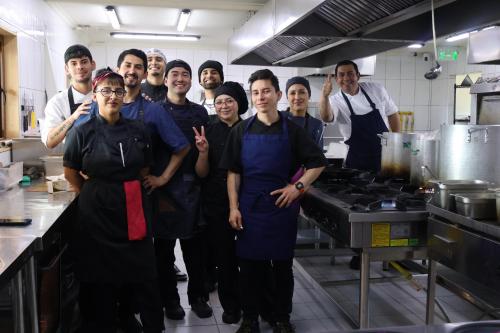 a group of chefs posing for a picture in a kitchen at Pampa Lodge, Quincho & Caballos in Torres del Paine