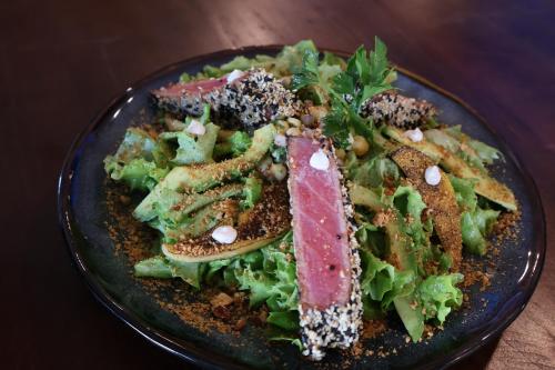 a plate of food with a salad on a table at Pampa Lodge, Quincho & Caballos in Torres del Paine