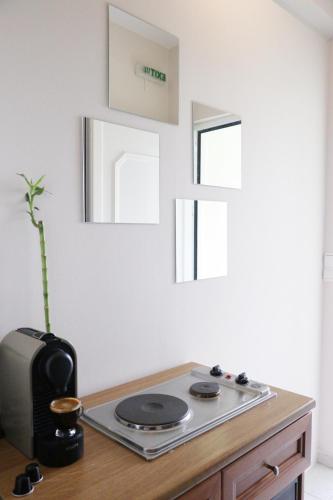 a kitchen with a table with a stove and windows at Arillas view 2 in Kefalári
