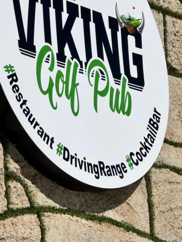 a sign for a wine golf pub on a brick wall at BELKA GOLF RESİDENCE Luxury Apt Poolside Belek in Belek