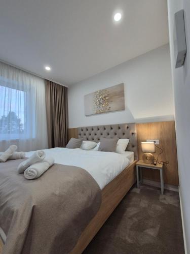 a bedroom with two beds and a window at Hotel Park in Valpovo