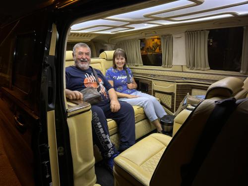 a man and woman sitting in the back of an rv at BELKA GOLF RESİDENCE Luxury Apt Poolside Belek in Belek