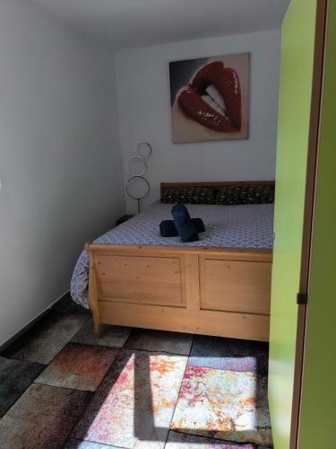 a bedroom with a bed with a teddy bear on it at Confort & calme à Bruay afin d'explorer le Nord in Bruay-la-Buissiere