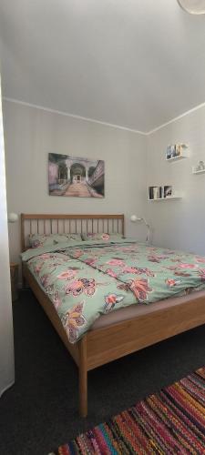 a bedroom with a large bed with a colorful comforter at Kissinger38 in Detmold