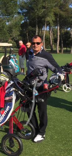 a man standing next to a bike in a park at BELKA GOLF RESİDENCE Deluxe apt Poolside BELEK in Belek
