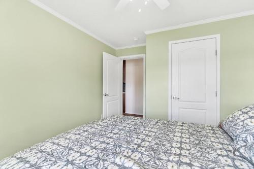 a bedroom with a bed and an open door at Hidn LakeFront-New Build-Private Beach-Fast Wi-Fi in Brighton