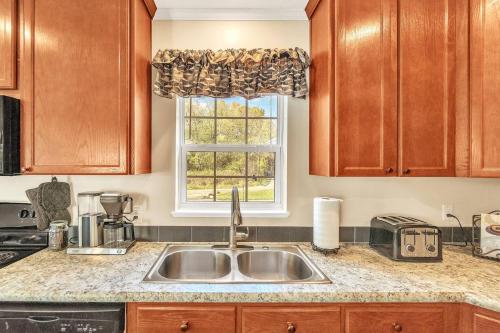 a kitchen with a sink and a window at Hidn LakeFront-New Build-Private Beach-Fast Wi-Fi in Brighton