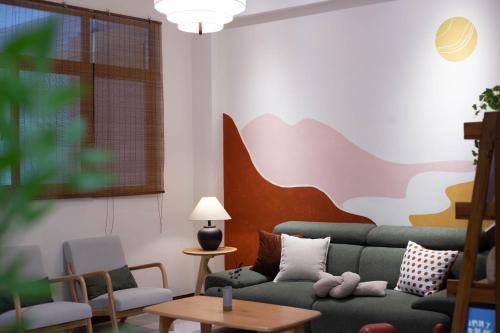 a living room with a couch and a table at 出水茶旅民宿 in Zhuqi