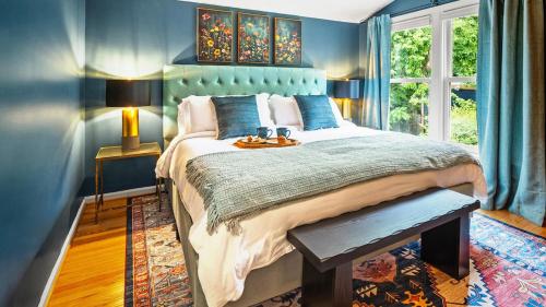a bedroom with a large bed with blue walls at The Madison in Alexandria