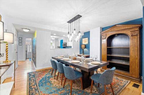 a dining room with a table and blue chairs at The Madison in Alexandria
