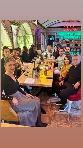 a group of people sitting at a table in a restaurant at Belka Golf Residence Exclusive Apt Poolside in Belek