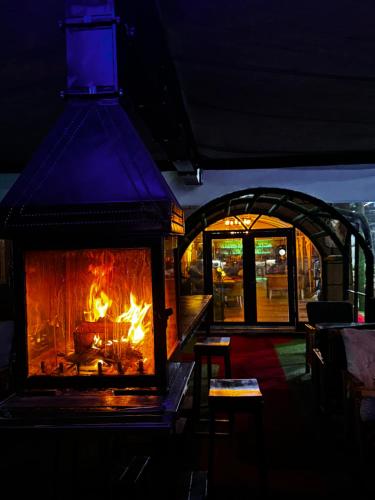 a fireplace in a restaurant with a fire in it at Belka Golf Residence Exclusive Apt Poolside in Belek