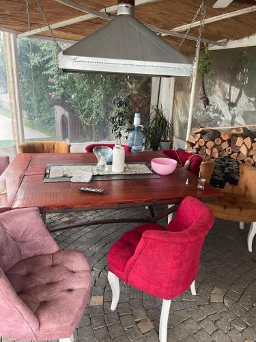 a wooden table with pink chairs in a room at Belka Golf Residence Exclusive Apt Poolside in Belek