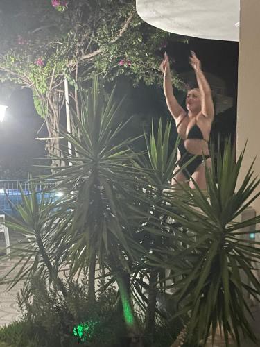 a man jumping in the air on top of a plant at BELKA GOLF RESİDENCE Poolside apt1 Belek in Belek